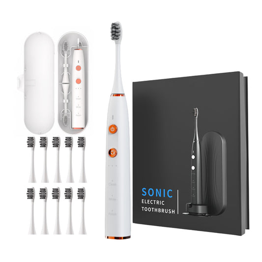 White electric toothbrush with packaging and additional brushes on a white background
