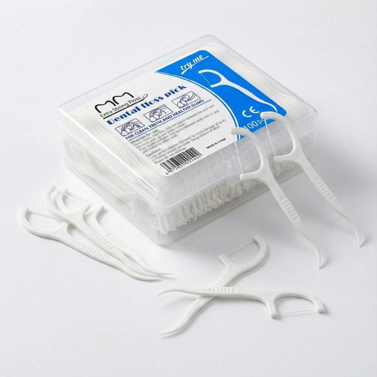 Dental floss pick packaging with floss picks on a white background