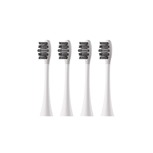 Four white electric toothbrush heads with black bristle patterns on a white background