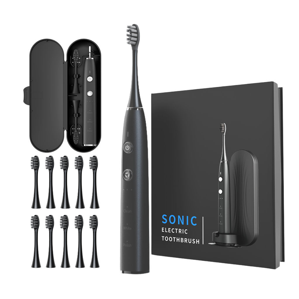 Black electric toothbrush set with multiple brush heads and packaging on a white background