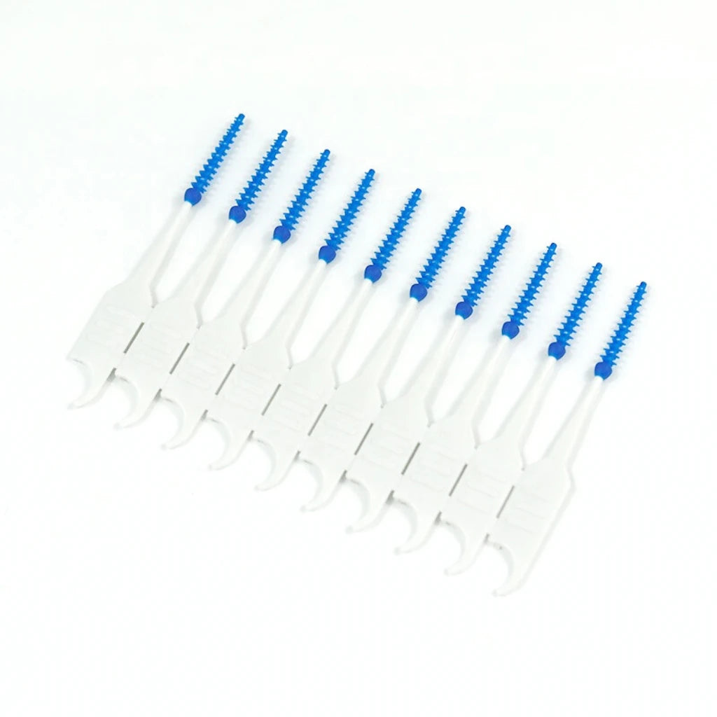 Set of dental cleaning tools with blue bristles on a white background