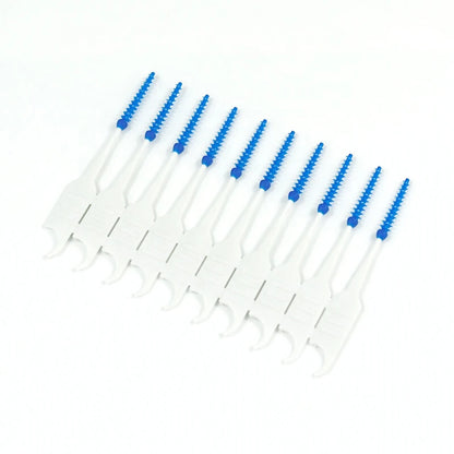 Set of dental cleaning tools with blue bristles on a white background